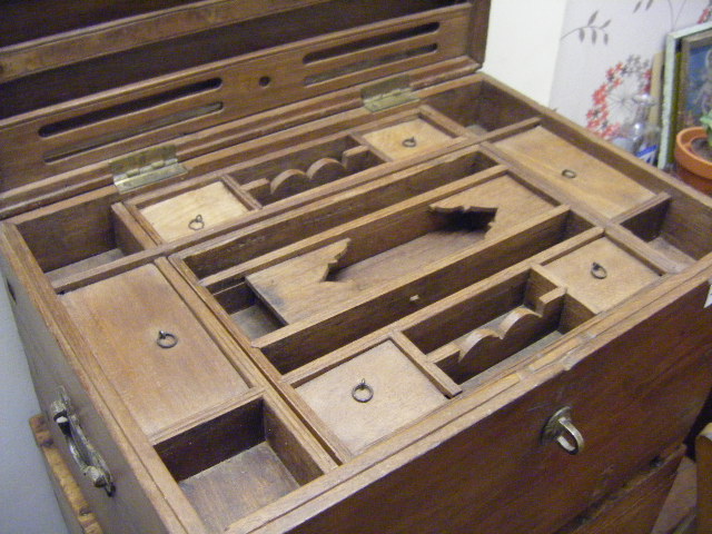 An example of a fine teak chest with multiple compartments.