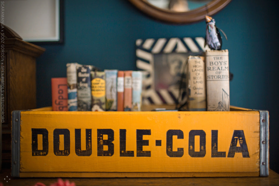 This vintage soda crate gives a bedroom a simple hint of industrial style, while storing books